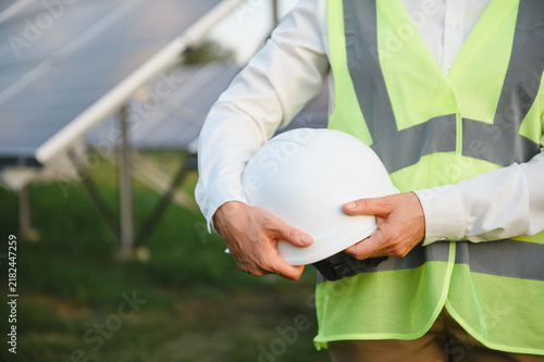 Obraz na płótnie Engineer worker holding hard hat at solar farm