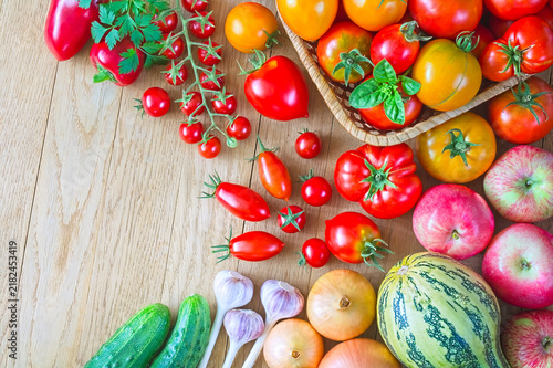 Fresh Ripe Tomatoes and Mixed Vegetables and Fruits on Wooden Table
