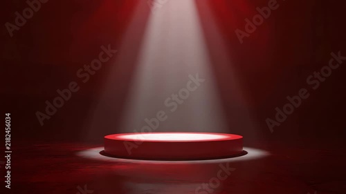 Red circular pedestal sits under bright vertical spotlight creating dramatic atmospheric motion in this premium product display animation video clip