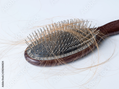 Fotografía Wooden Hairbrush Covered with Lost Hair Strands Symbolizing Alopecia and Hair Lo