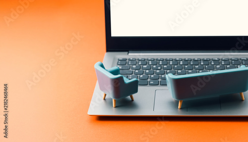 Laptop with blank screen and sofa for online streaming and entertainment mockup