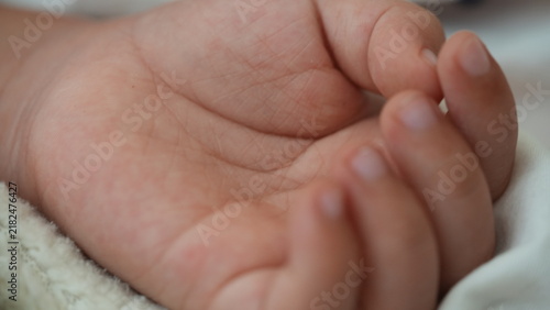 Fotografie Close Up of Delicate Baby Hand Resting Peacefully