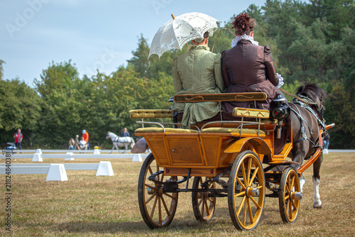 Naklejka Traditional Horse Drawn Carriage With Period Dressed Passengers at a British Carriage Driving Show
