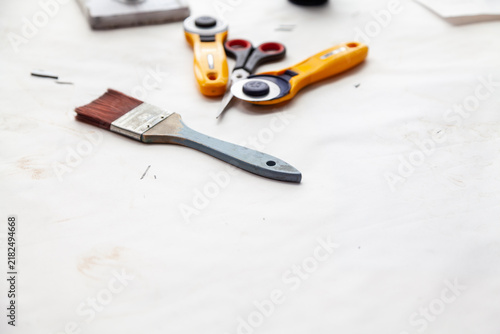brush scissors and rotary cutter lie on a white surface