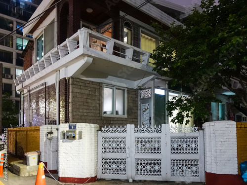 Photography TypicaI residential house exterior in urban South Korea, showing everyday urban living environment