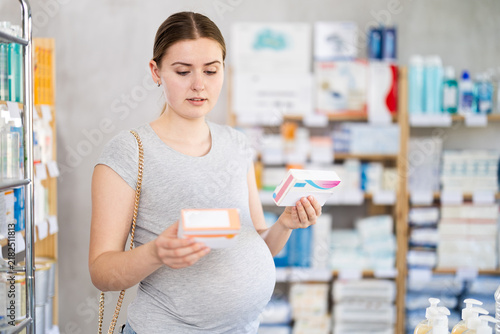 Pregnant woman buyer select buys vitamins medicine