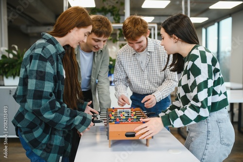 Cuadro en lienzo Startup employees playing table football during a break