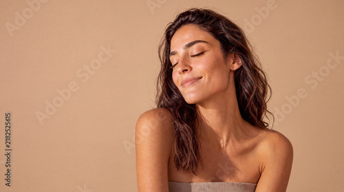 A woman's face expressing contentment, peace, well-being, and relaxation