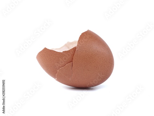 Empty cracked brown chicken eggshell standing on a clean white background. Perfect macro image for food, cooking, baking ingredients, farm products, fragile concepts, and culinary preparation
