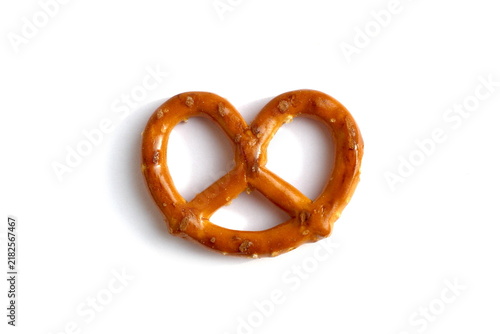 One crispy pretzel cracker lies on a white background.
