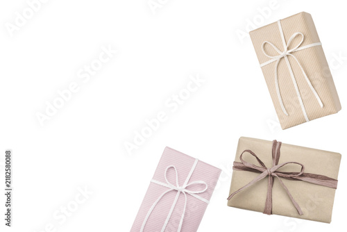 A cutout image of three gifts: two wrapped in kraft paper and one in soft pink paper.