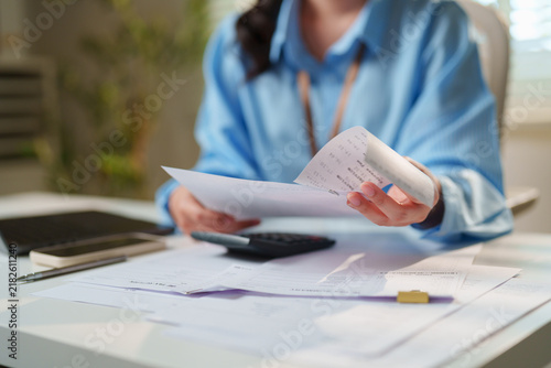 Cuadro en lienzo Accountant auditing paper receipts and financial summary documents with a calcul