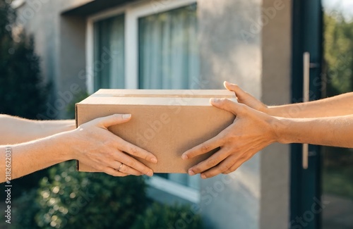 Delivery Person Handing Over Package to Customer Outside
