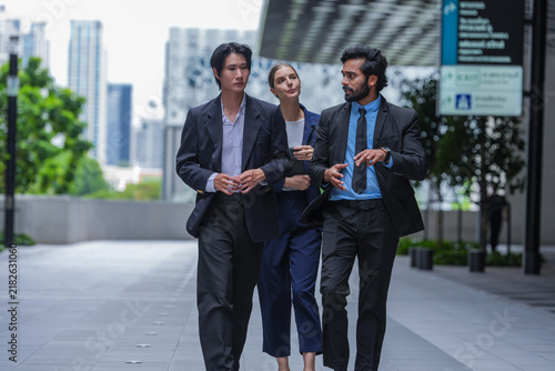 Fotografie A multiethnic business team of three colleagues seal an agreement with a handsha