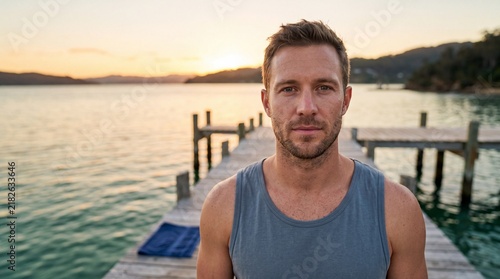 Confident Man Relaxing on Wooden Pier at Sunset