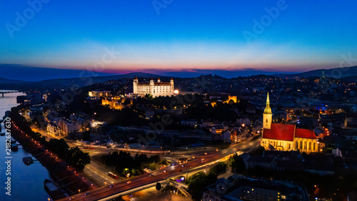 Fotografie Bratislava at dusk with the castle and city lights visible along the Danube River
