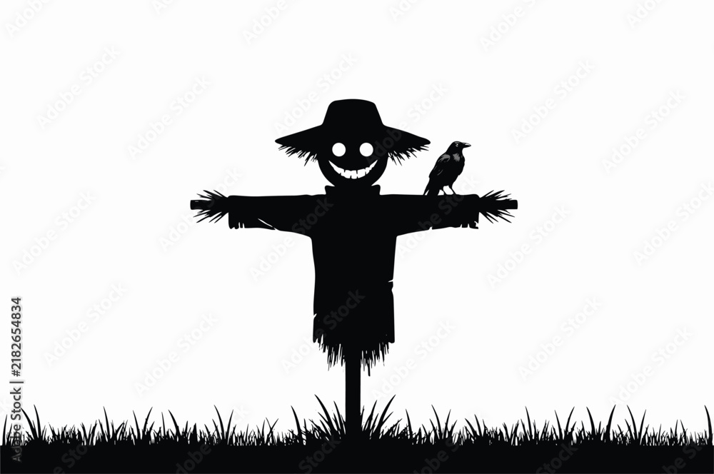 Fototapeta premium Black silhouette of a scary scarecrow with a wide grinning face and a straw hat standing in a field with a crow perched on its arm isolated on a white background