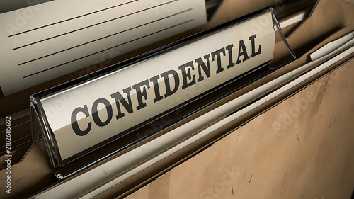 Close up of a 'confidential' label on a stack of files emphasizing secrecy