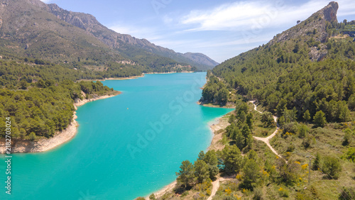 Картината върху платно Guadalest reservoir turquoise water reflecting mountains in Spain