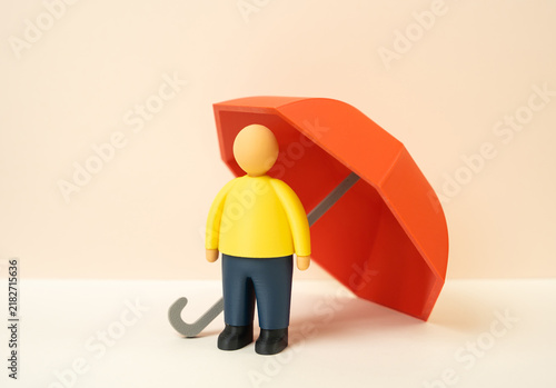 Bild auf Leinwand Person under a red umbrella, insurance concept