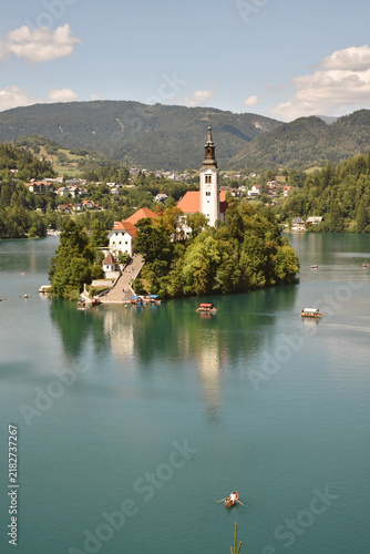 Scenic view of Lake Bled in Slovenia with island church, surrounded by mountains and calm turquoise water