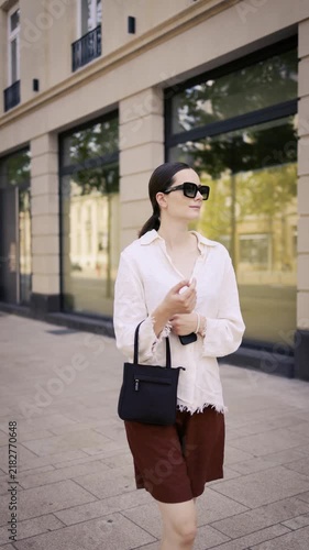 Young woman walking through Luxembourg City center and exploring historic architecture on a sunny summer day. Urban travel footage ideal for tourism, European lifestyle.