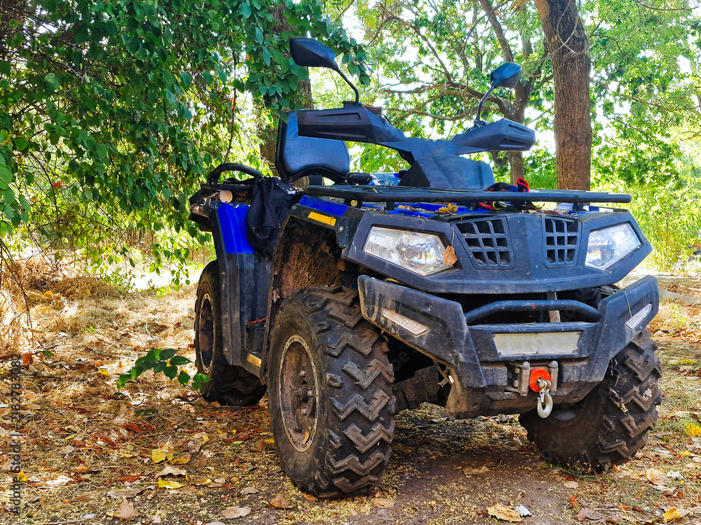 Fototapeta premium Off-road vehicle in the jungle. Quad bike on the road.