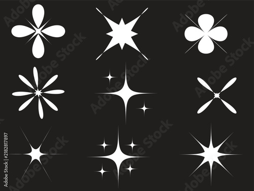Set of various white sparkle icons and glowing star shapes on a dark background