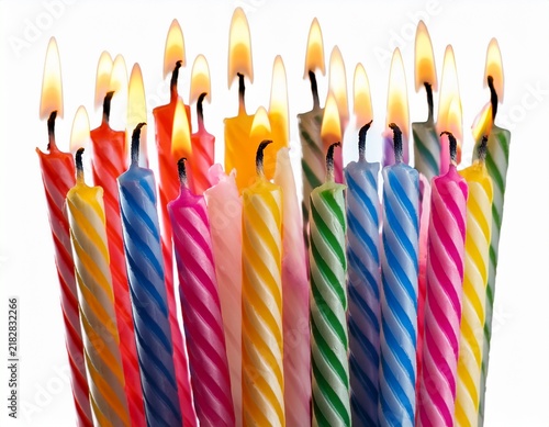 colorful birthday candles lit up isolated on white background