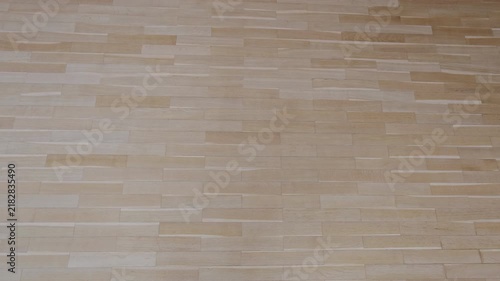 Smooth camera movement over a brand new light brown parquet floor. Clean wooden surface background perfect for architectural visualization