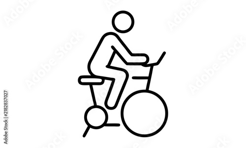 Person riding stationary bike for fitness and exercise routine