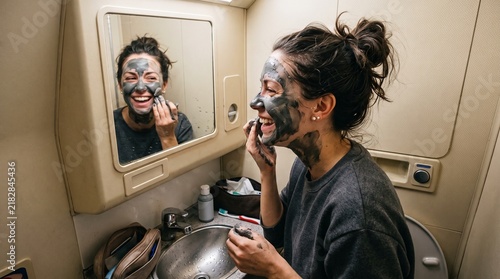 Woman applying clay mask
