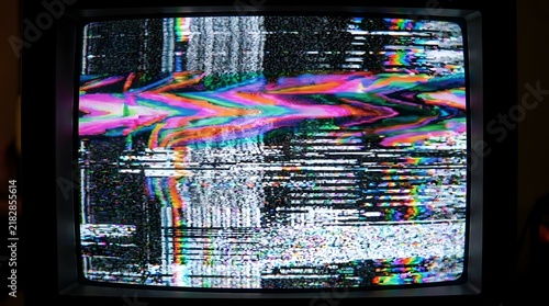 Grainy VHS tape glitch burn with tracking noise and neon color fringing