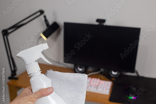 Konstfotografi The cleaning of the home office desk setup - Hand holding spray and cleaning clo