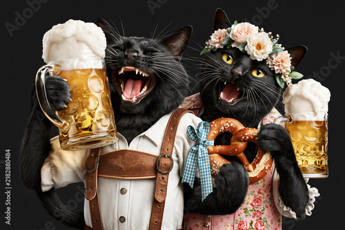 Two cats in Bavarian outfits toasting beer mugs with pretzel isolated on black background, Oktoberfest concept