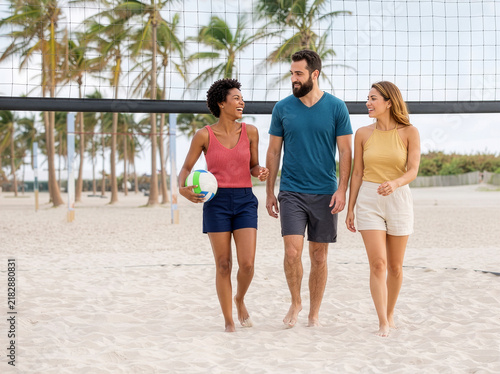 Group of people walking on beach after playing Volleyball