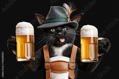Black cat licking lips in Bavarian hat holding beer mugs isolated on black background, Oktoberfest concept