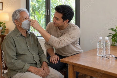 Caregiver Helping Elderly Man Fit Protective Mask at Home