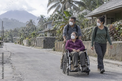 Community Assisting Wheelchair User During Volcanic Evacuation