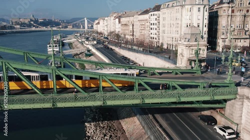 Aerial Shot of Yellow Tram Crossing Liberty Bridge in Budapest