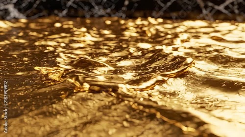 Golden liquid flowing in a smooth manner with reflections in a dimly lit space