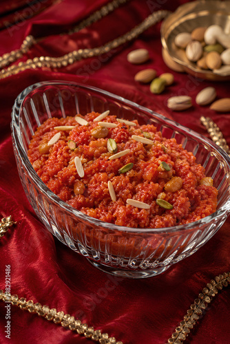 Traditional Gajar Halwa With Almond Slivers on Festive Red Fabric