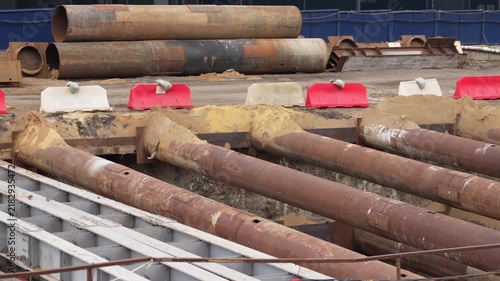 Large steel tubular supports used as temporary bracing system during underground construction works, stabilizing excavation structures at an urban infrastructure project