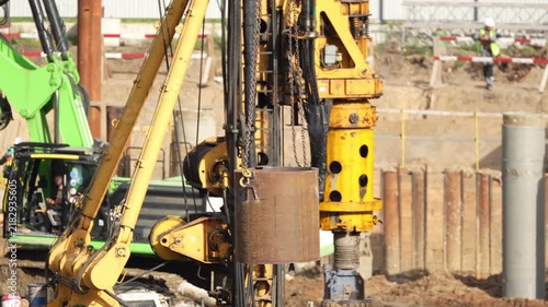 Large construction drilling machine performing deep foundation piling operations, showing heavy equipment and engineering works for modern urban infrastructure development