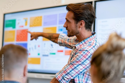 Business presentation with male speaker pointing at screen