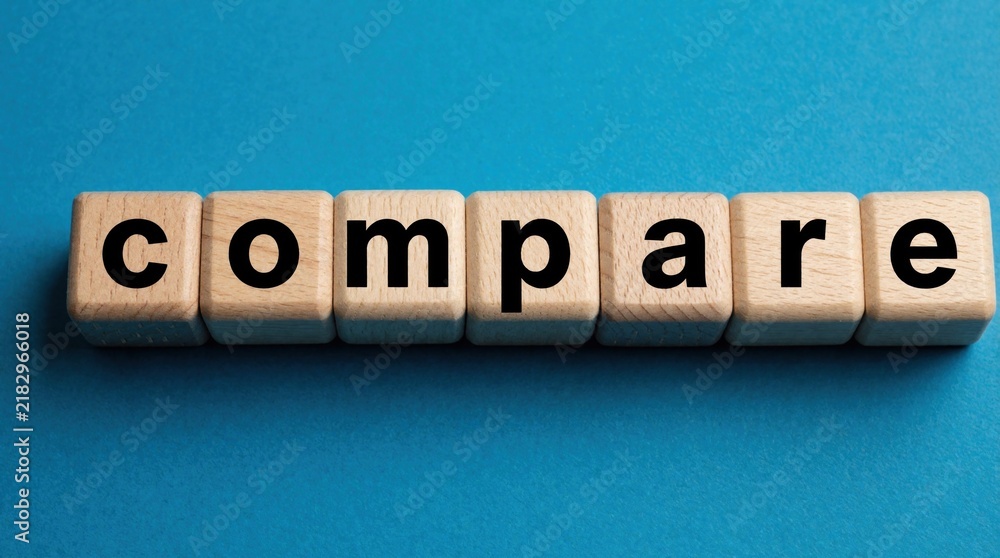 Naklejka premium Wooden blocks spell out the word compare on a blue background. This represents analysis and choice making in business decisions and strategy.