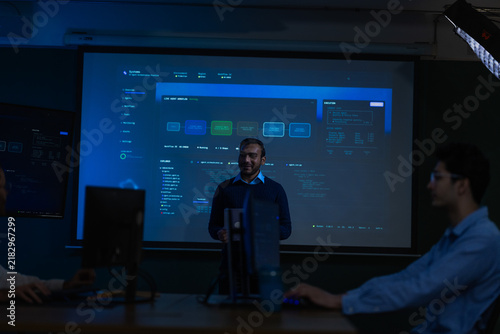 Quadro su tela A male technology presenter in a navy cable knit sweater and white collar gestur