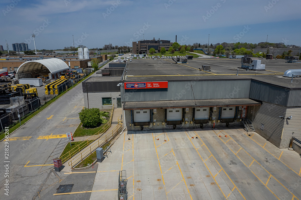 Obraz premium Canada Post building's loading dock. Canada’s national postal service distribution building the Crown corporation responsible for delivering mail and parcels: Toronto, Ontario, Canada - May 17, 2026