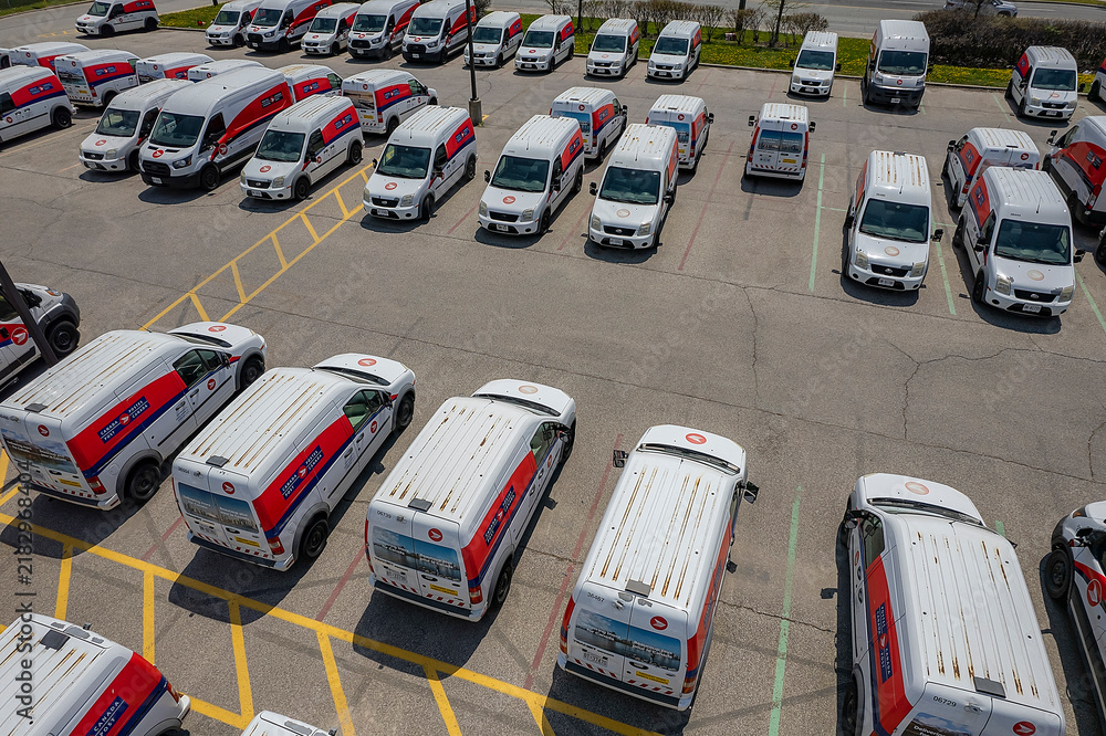 Obraz premium Canada Post delivery vans parked in a fleet parking lot. Canada. Canada Post is discontinuing door-to-door delivery and transitioning to community mailboxes: Toronto, Ontario, Canada - May 17, 2026