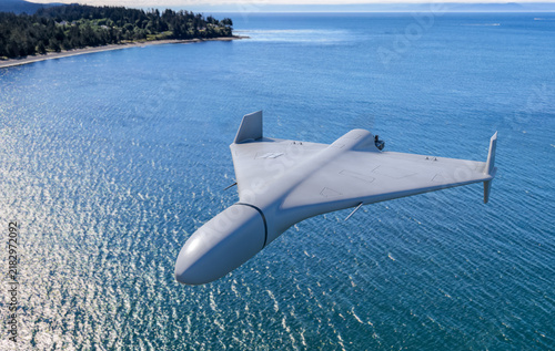 Unmanned Stealth Drone Flying Over Blue Ocean Coastline With Aerial Surveillance View